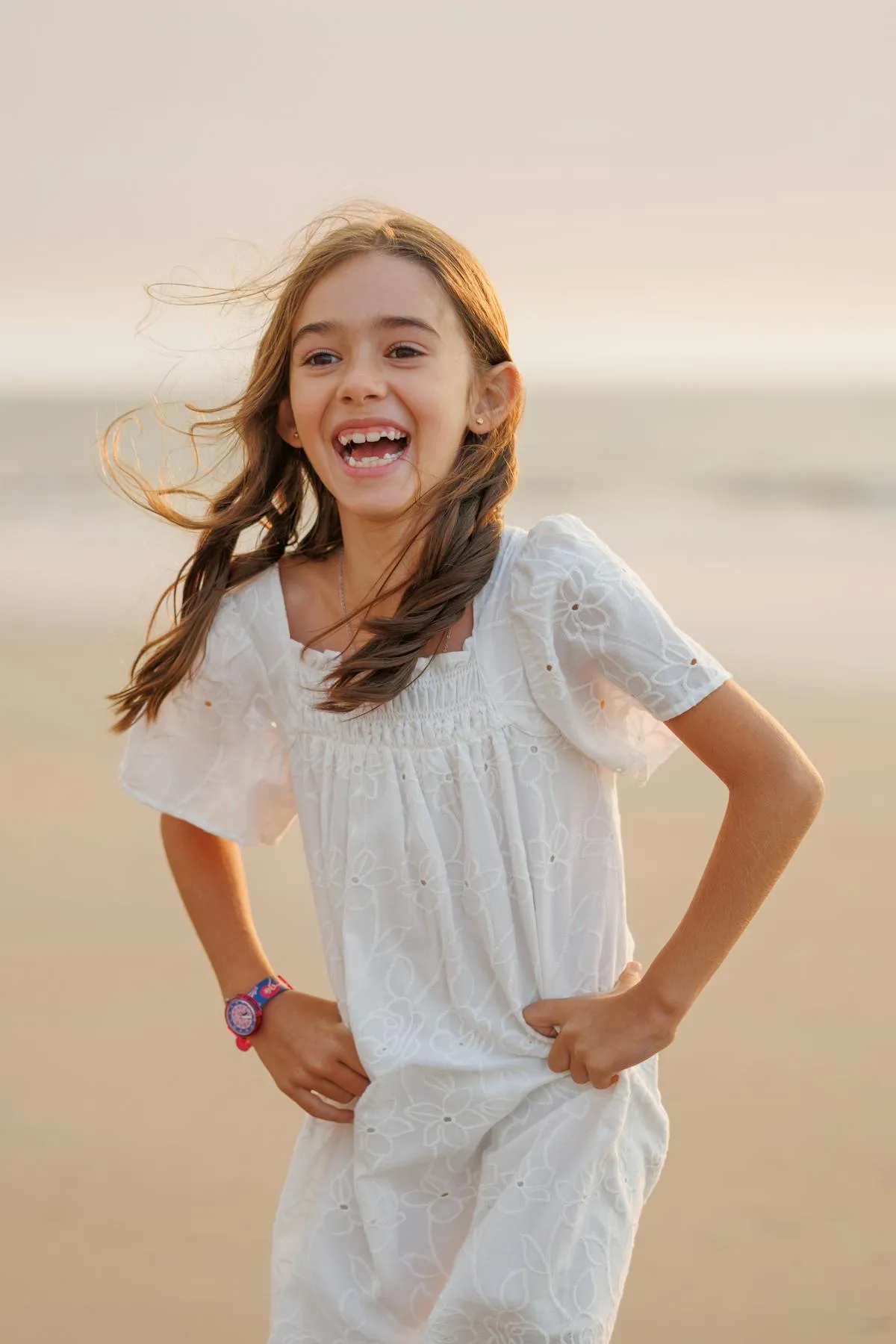 Joyful young girl laughing on the beach at sunset in Broome